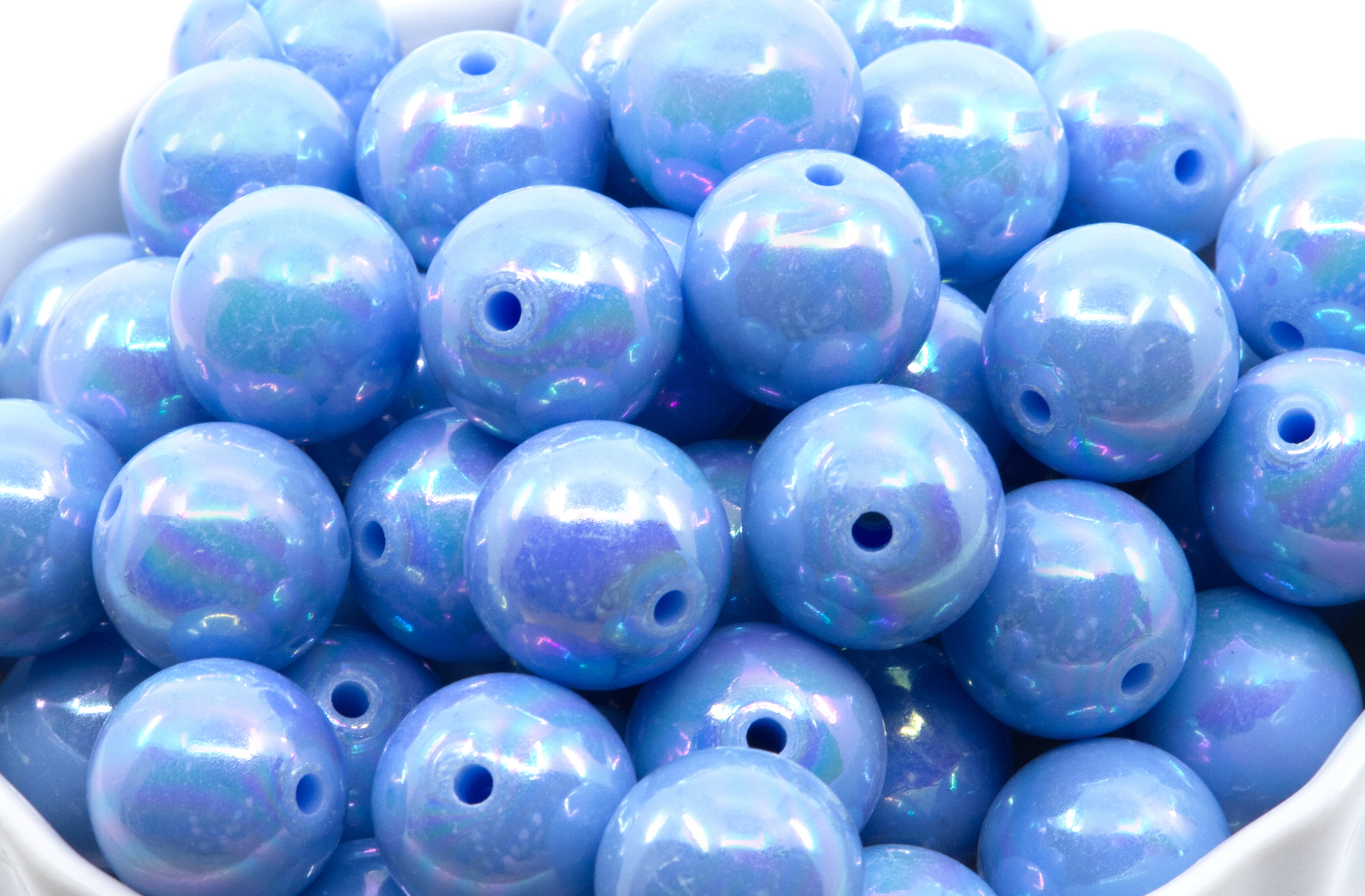 blue iridescent beads in a white bowl
