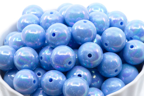 Blue iridescent beads in a white bowl