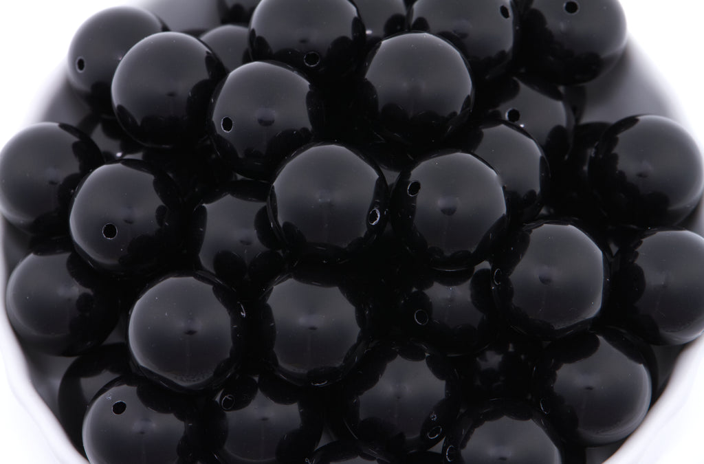 Close-up of black beads on a white background