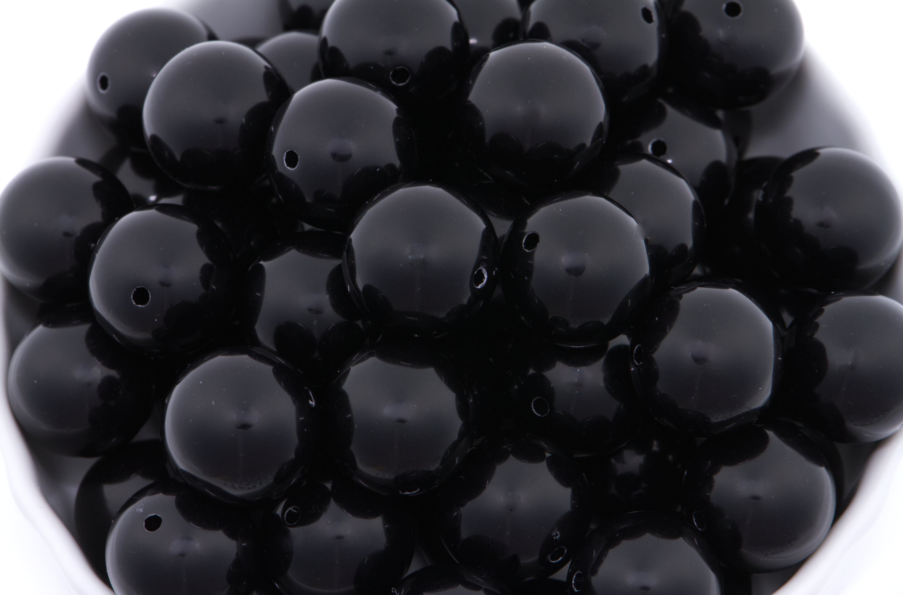 Close-up of black beads on a white background