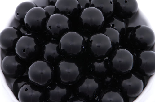 Close-up of black beads on a white background