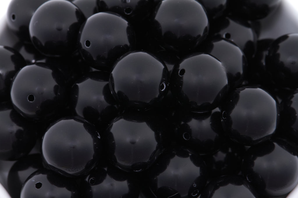 black beads on white background
