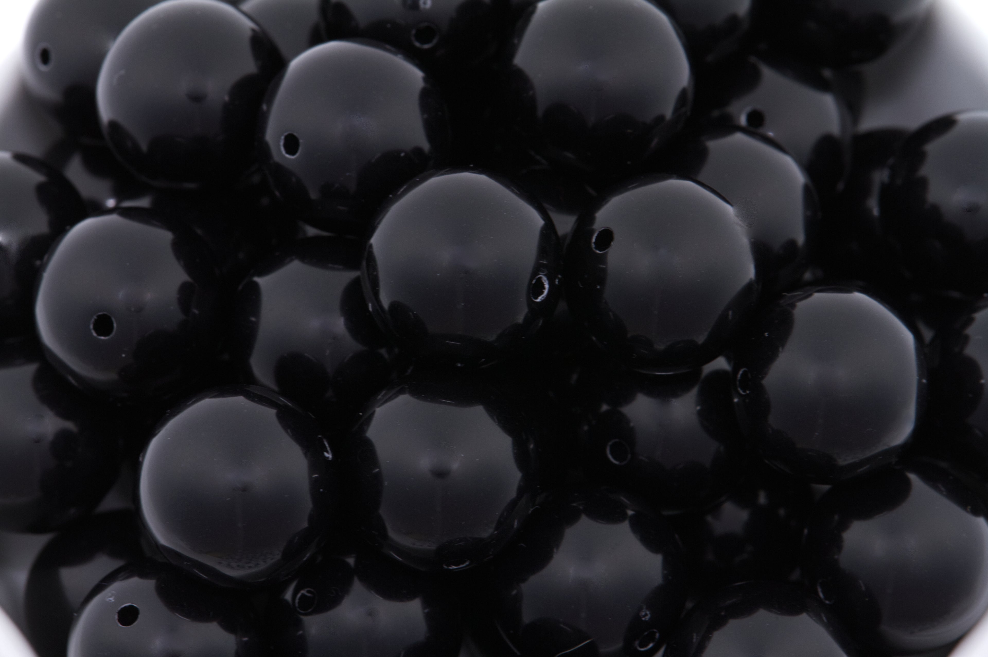 black beads on white background