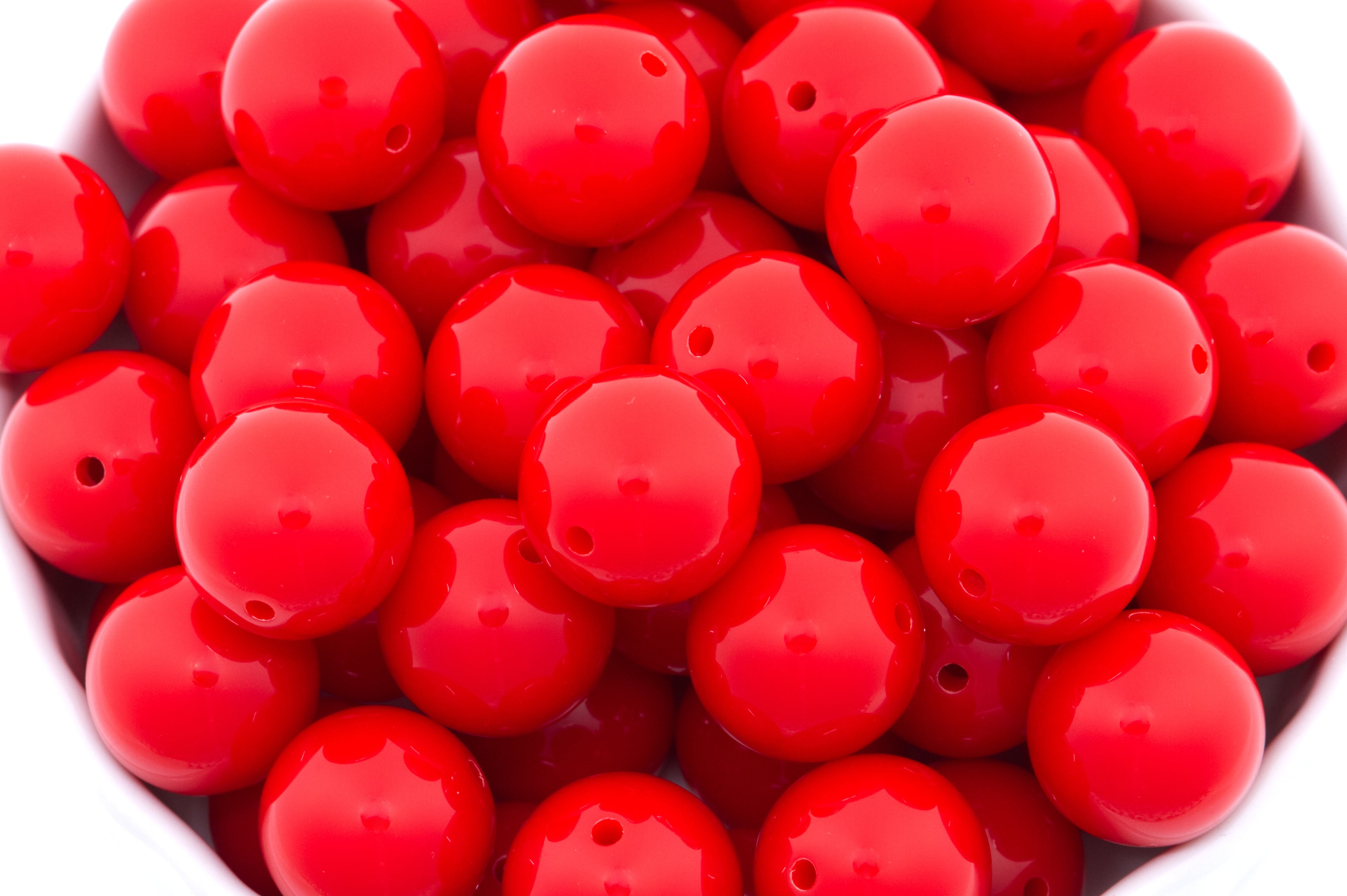 reds beads in a white bowl on a white background