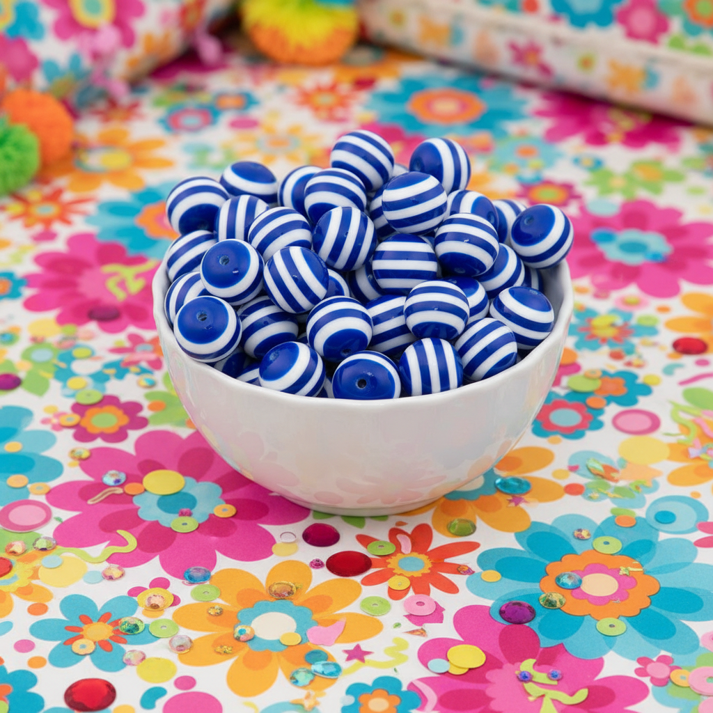 Blue and white striped beads piled in a small white bowl, set on a colorful floral surface.
