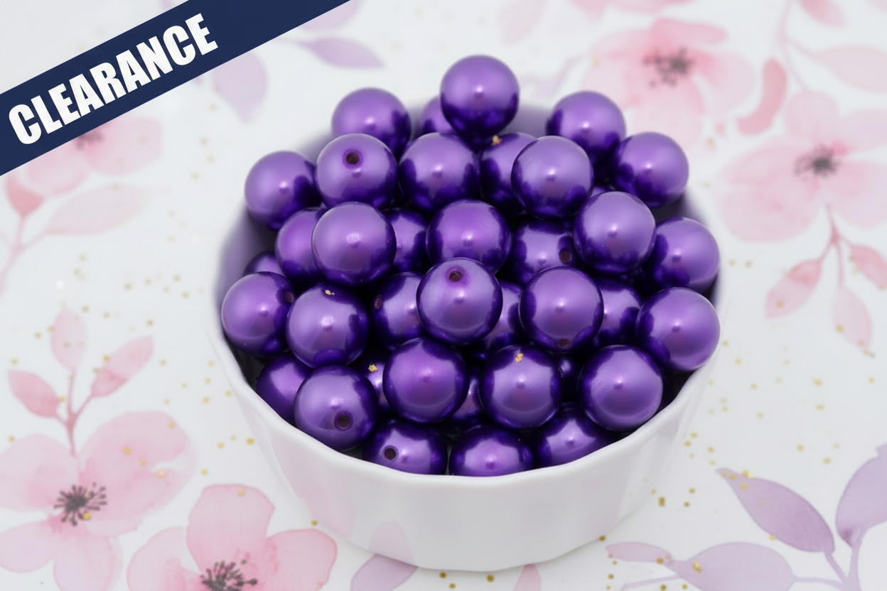 Purple metallic beads in a white bowl on a floral background. clearance label on top left corner