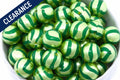 Close up of green striped metallic beads in a white bowl on a white background. clearance label on top left corner 