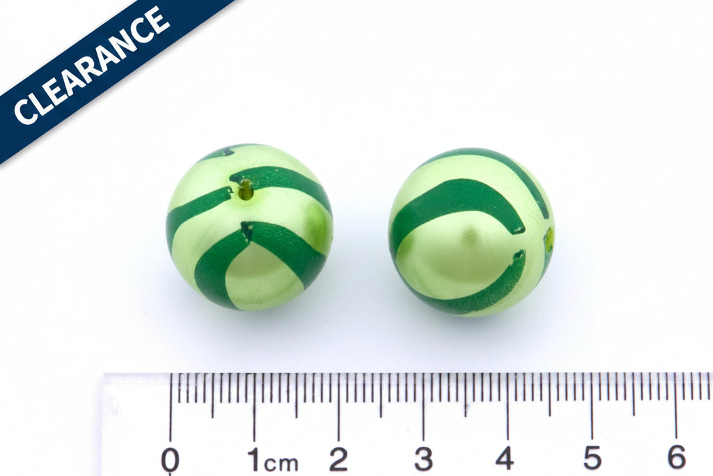 two green striped metallic beads next to a ruler for scale on a white background. clearance label on the top left corner 