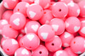 Close-up of pink beads with white heart patterns