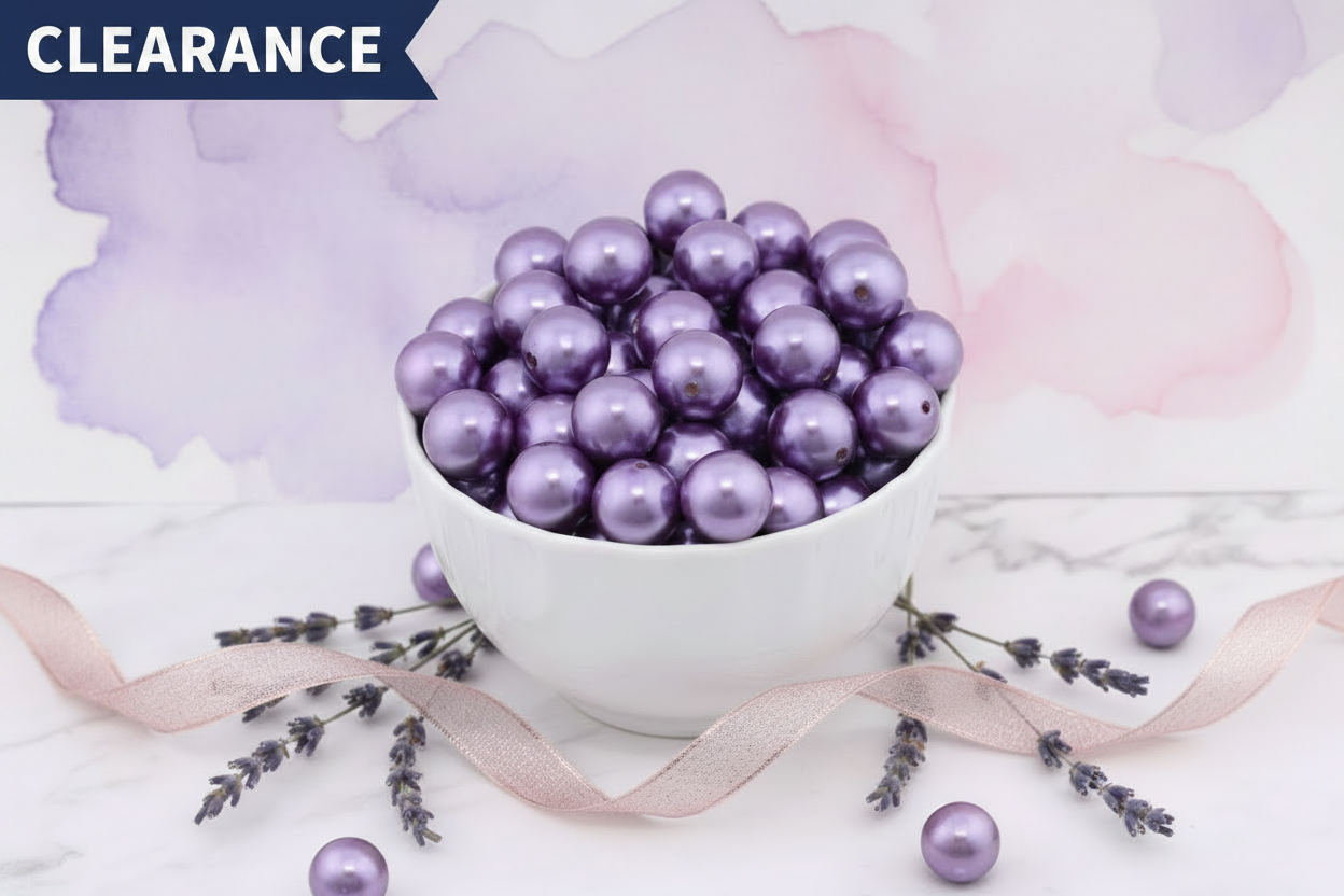 Purple metallic beads in a white bowl with lavender flowers on a soft background. clearance label on the top left corner.