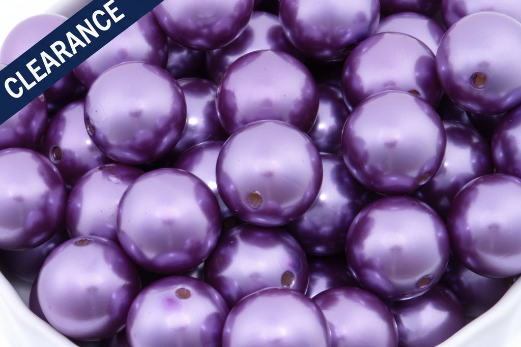 Close-up of purple metallic beads with a 'Clearance' label on the top left corner.