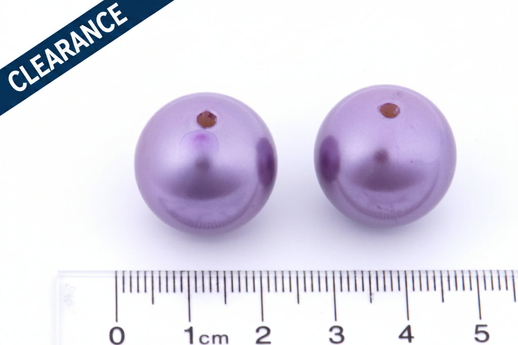 Two metallic purple beads with a ruler for scale on a white background, clearance label on the top left corner.