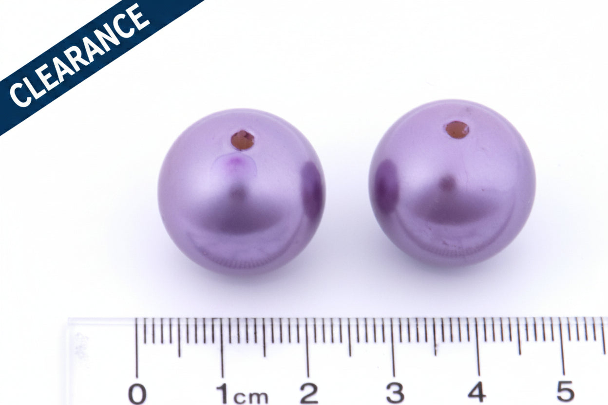 Two metallic purple beads with a ruler for scale on a white background, clearance label on the top left corner.