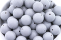 gray beads in a white bowl on a white background