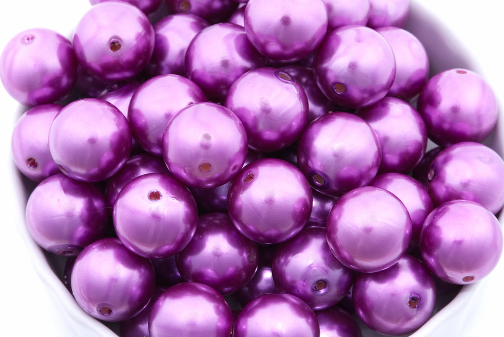 purple bubblegum beads in a white bowl on a white background 
