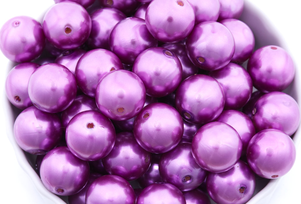 purple bubblegum beads in a white bowl on a white background 