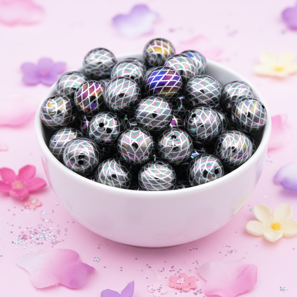 A white ceramic bowl filled with black iridescent beads featuring a mermaid scale print, set against a pink background decorated with pastel flower petals and glitter.