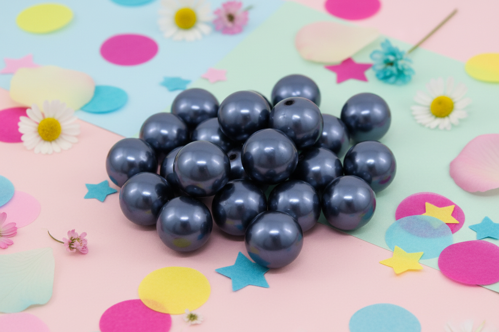 Dark blue metallic beads on a colorful background with flowers and stars