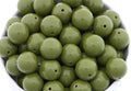 green beads in a white bowl on a white background