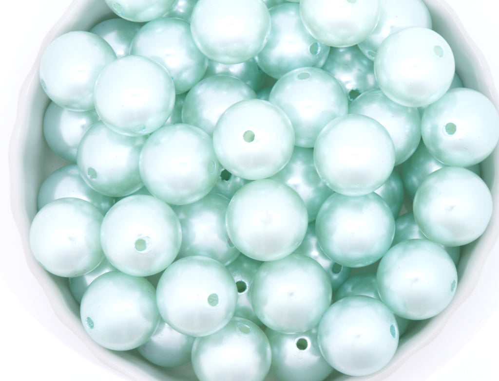blue bubblegum beads in a white bowl on a white background