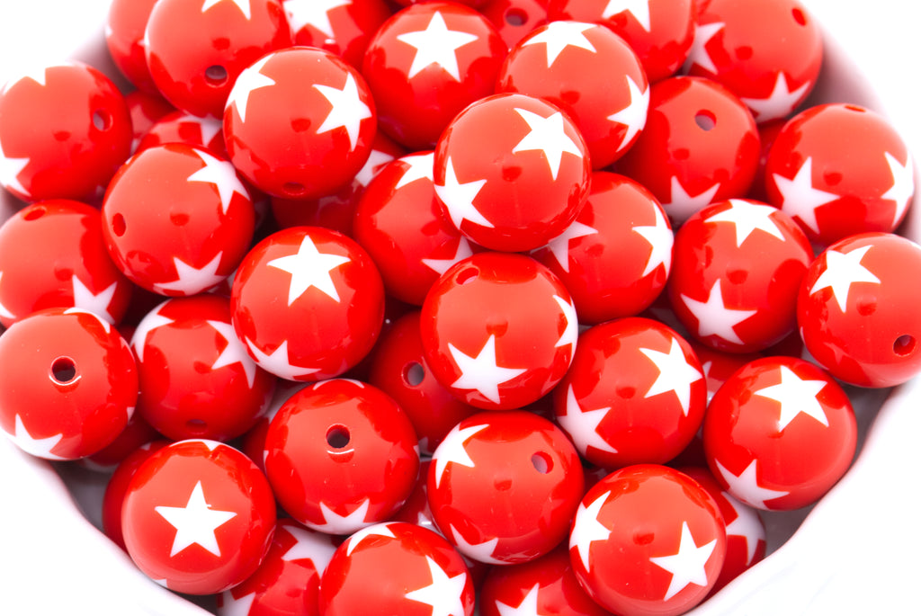 Red beads with white star patterns on a white background