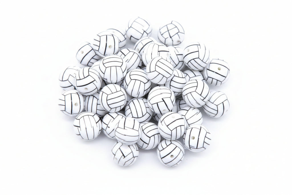 A pile of volleyball bubblegum beads, arranged  against a white background.