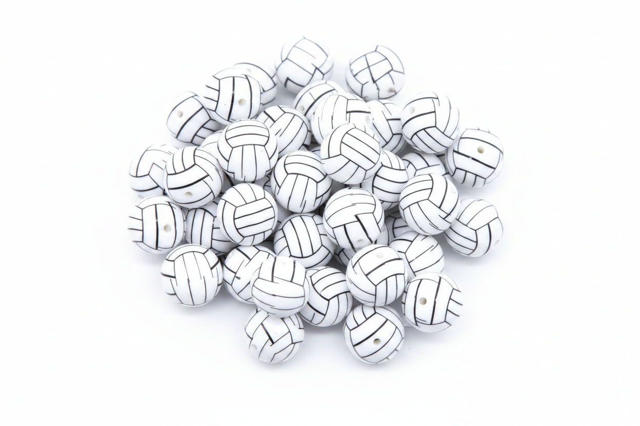 A pile of volleyball bubblegum beads, arranged  against a white background.