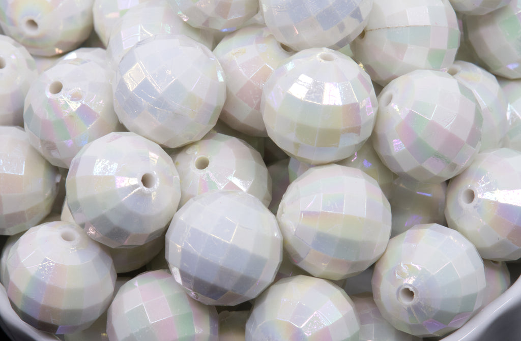 Close-up of white faceted beads in a white bowl