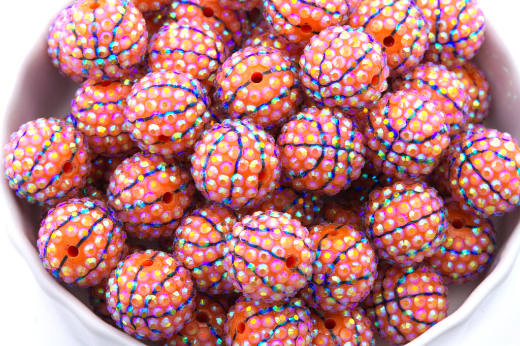 Colorful basketball rhinestone beads in a white bowl