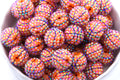 Colorful basketball rhinestone beads in a white bowl