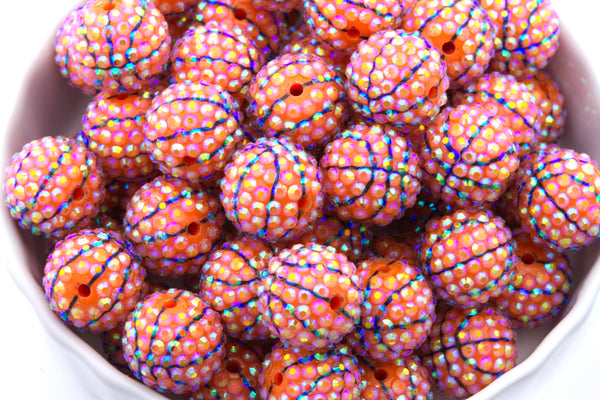 Colorful basketball rhinestone beads in a white bowl