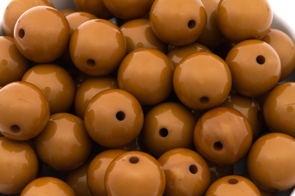 brown beads with a blurred white background