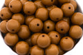 brown beads in white bowl on a white background