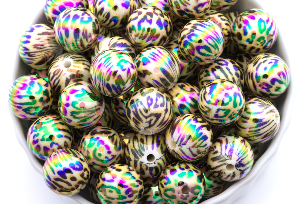 cheetah print round beads in a white bowl with a white background