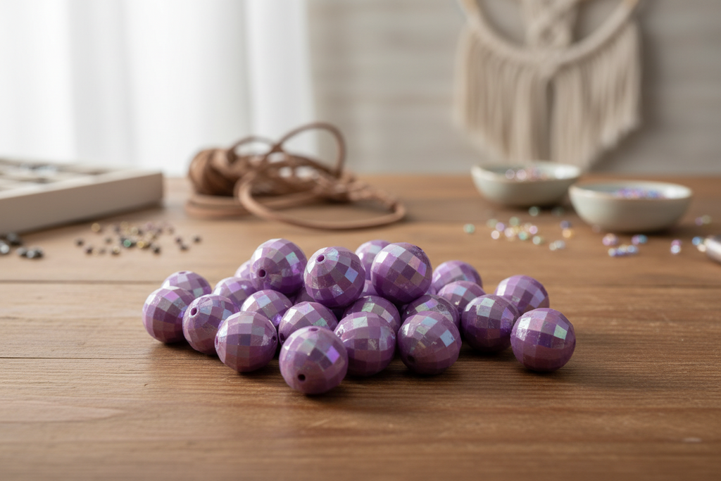 Purple faceted beads on a wooden surface with a blurred background