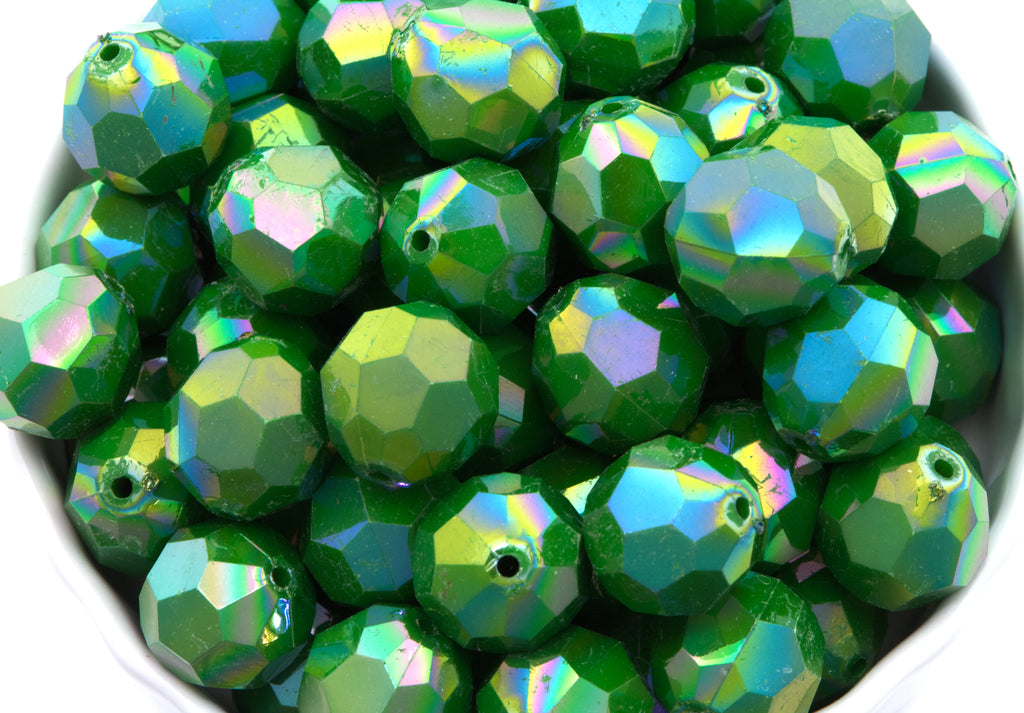 green faceted beads in a white bowl on  a white background