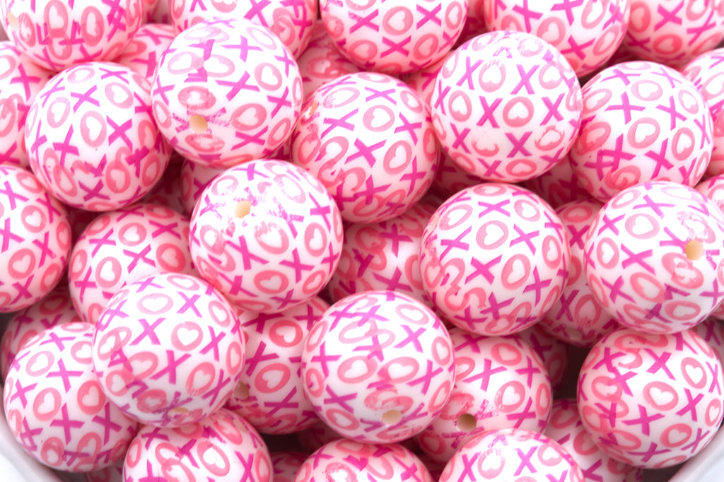 Close up of pink beads with XOXO pattern 