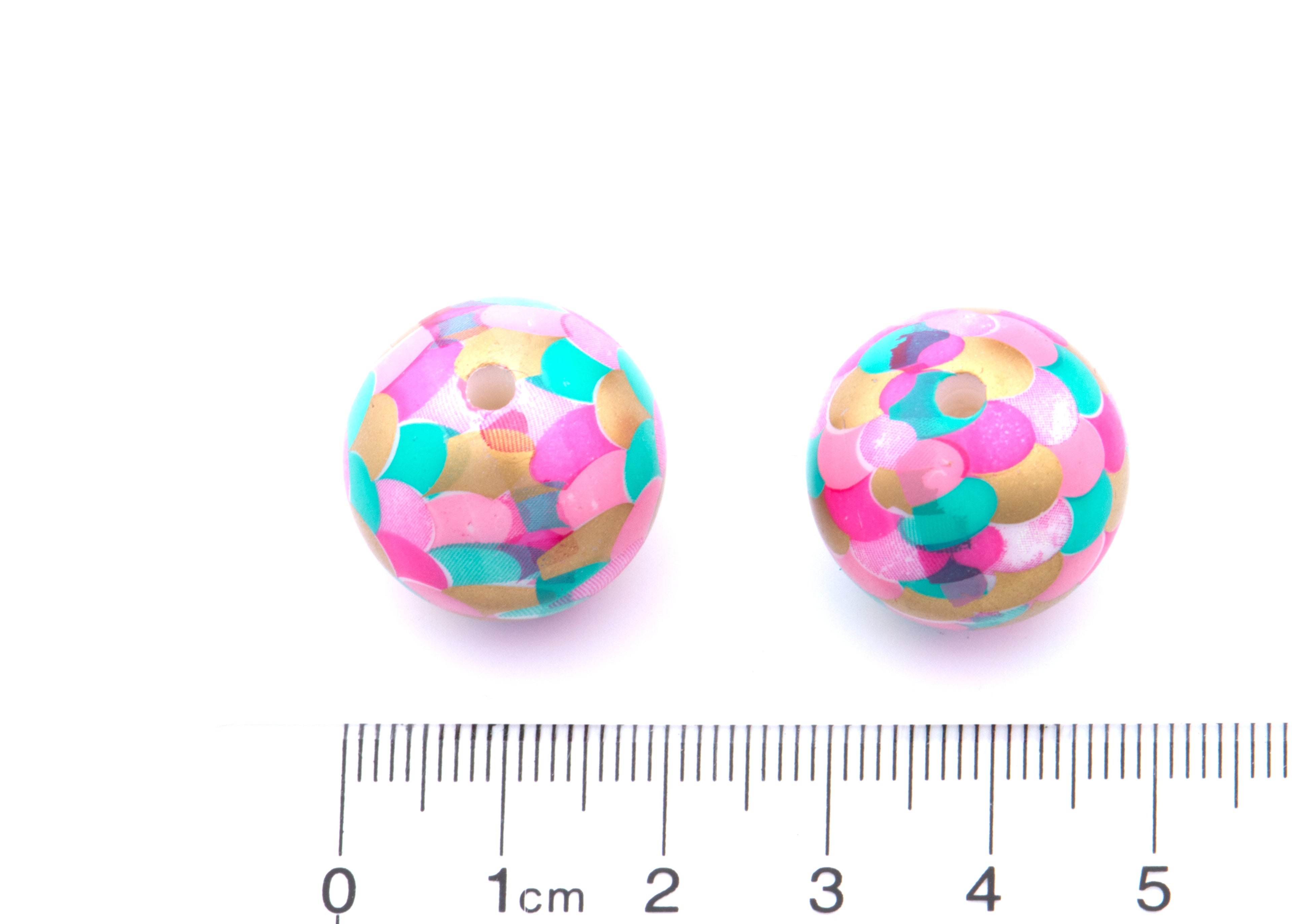 Two round mermaid scale bubblegum beads in a pattern of pink, teal, and gold, shown next to cm ruler for scale on a white background.