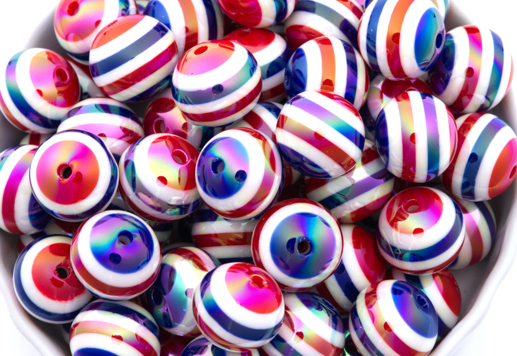 Red, White and Blue Striped beads in a white bowl on a white background