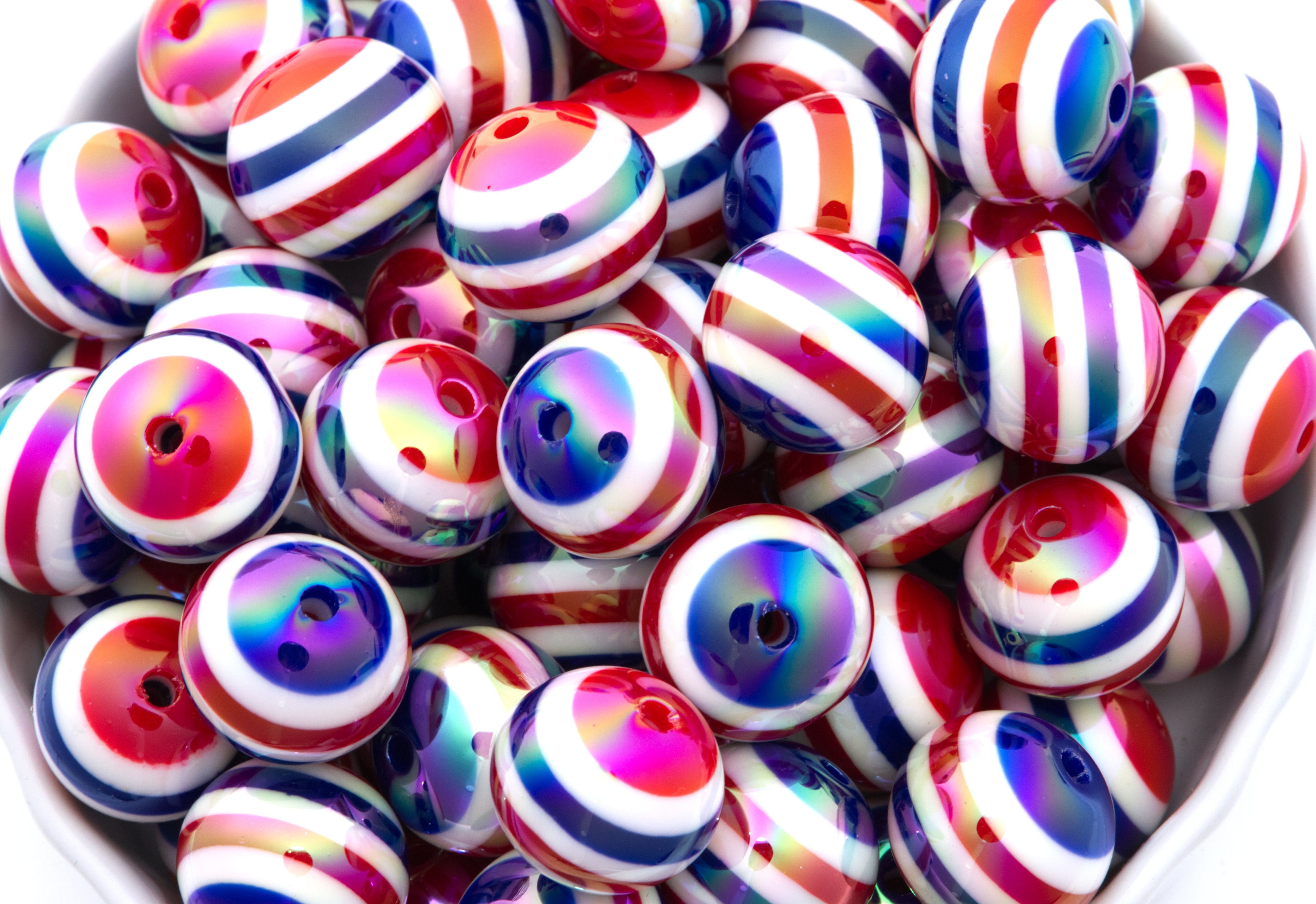 Red, White and Blue Striped beads in a white bowl on a white background