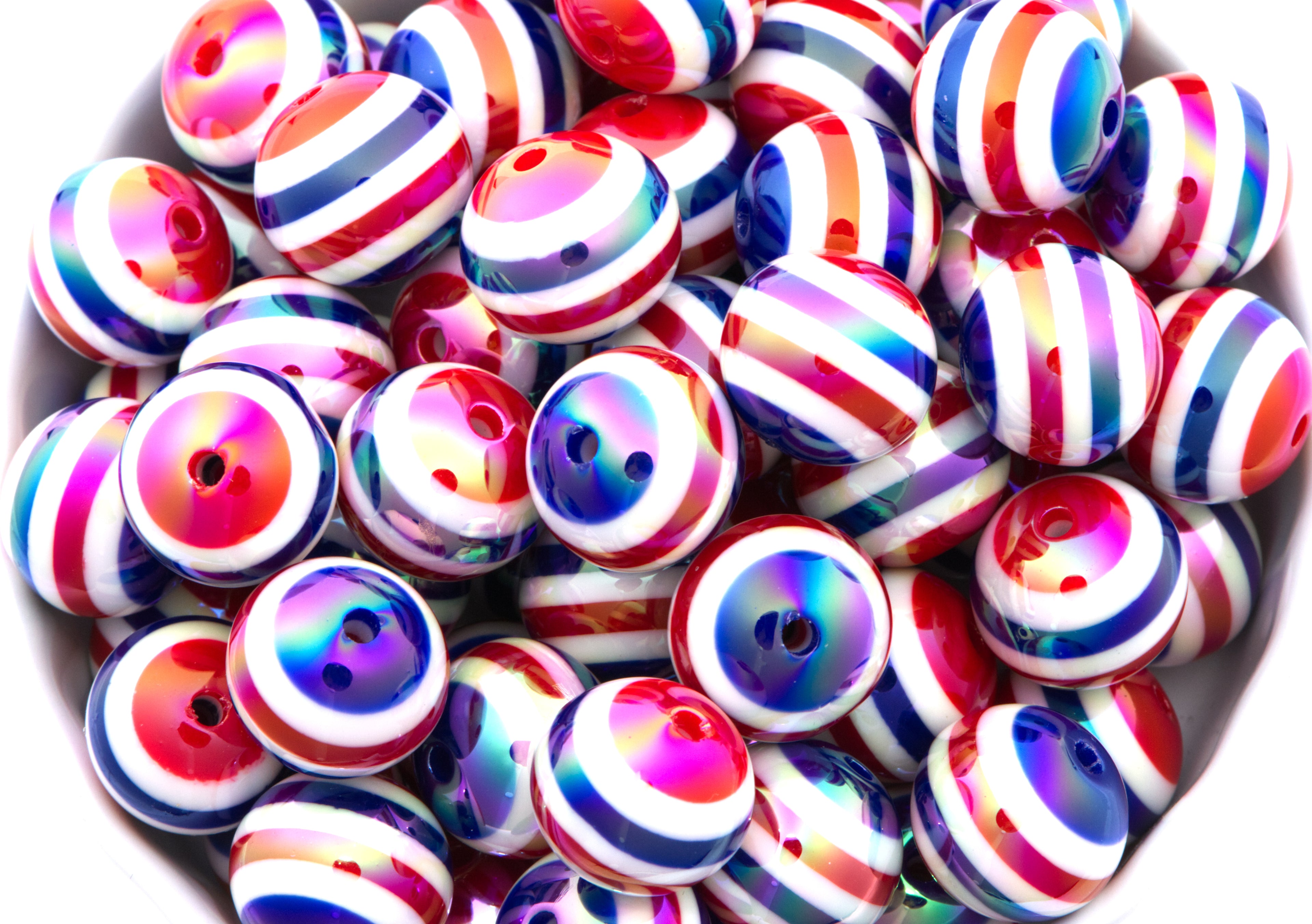 red, white and blue striped beads in a white bowl on a white background
