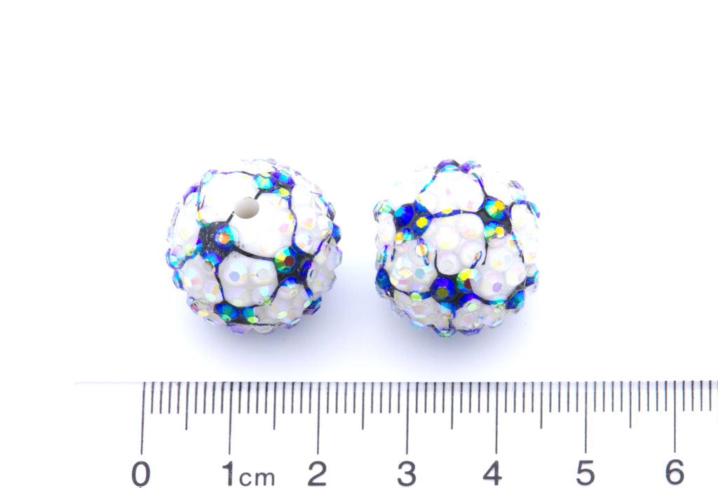 Two round soccer ball rhinestone beads shown next to a cm ruler for scale on a white background.