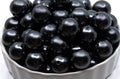 gray bubblegum beads in a white bowl on a white background 