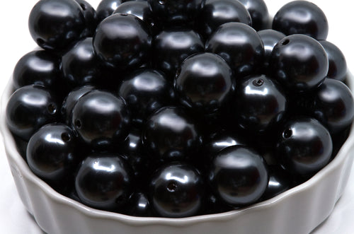gray bubblegum beads in a white bowl on a white background 