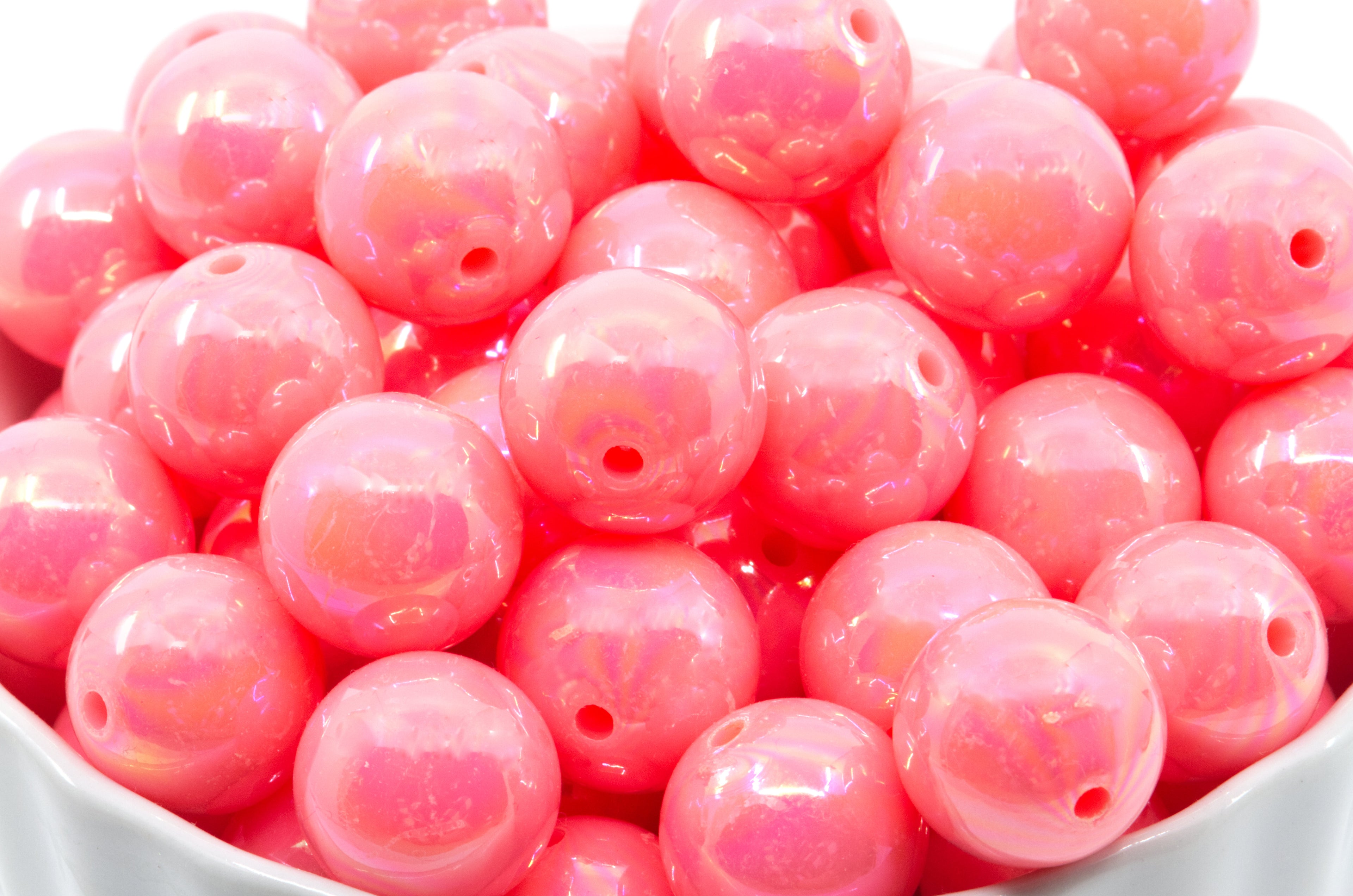 pink iridescent bubblegum beads in a white bowl