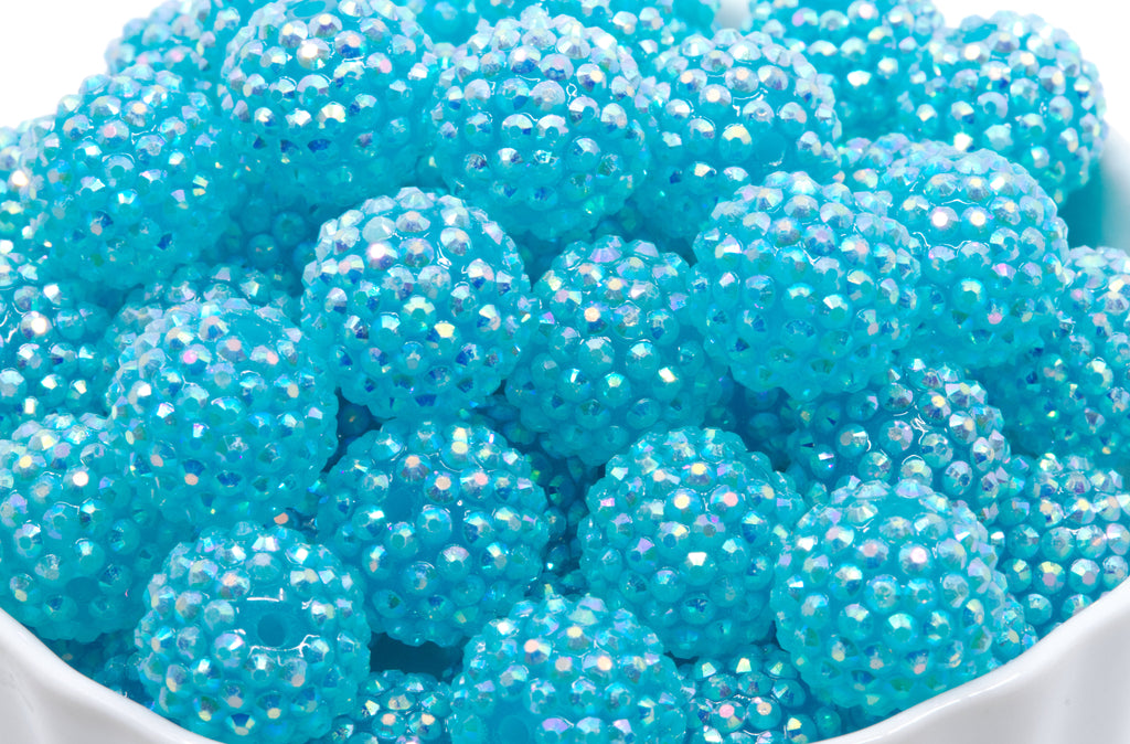 blue rhinestone beads in a white bowl