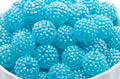 blue rhinestone beads in a white bowl