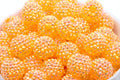 Close-up of orange rhinestone beads with a white background
