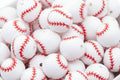 White baseball beads with red stitching in a white bowl