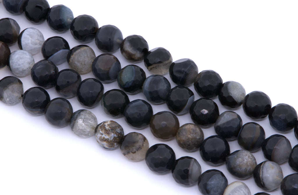 Faceted round agate beads in black and dark gray, arranged in four diagonal rows on a white background.